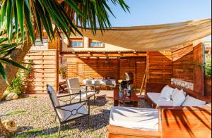 eine Terrasse mit Stühlen, einem Tisch und einem Zelt in der Unterkunft Breathtaking views and 2 swimming pools in Lavern