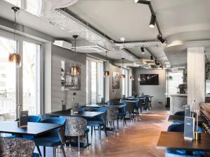 a row of tables and chairs in a restaurant at Hotel KUMP365 in Paderborn