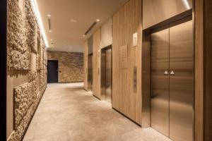 a hallway with a row of elevators in a building at Via Inn Prime Sapporo Odori in Sapporo