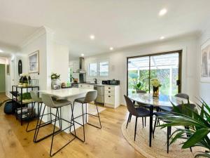 a kitchen and dining room with a table and chairs at Henderson House in Wentworth Falls