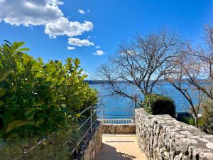 a stone wall with a view of the water at Apartment Golden Sun in Dramalj