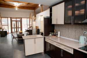 a kitchen with white cabinets and a dining room at EcoLodge in Wildlife Refuge in Urtsʼadzor