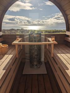 a room with a table and a view of the ocean at Vista Mara in Donegal