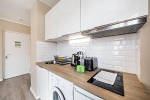 a kitchen with a sink and a counter top at Appartement Passion - moderne et lumineux AIL in Lyon