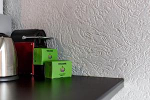 twee groene dozen op een tafel naast een muur bij Apartment for 4 people with view of Fourvière AIL in Lyon