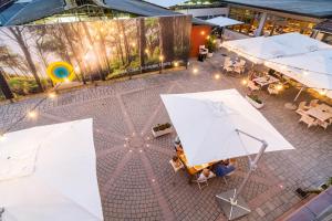 an overhead view of a patio with tables and umbrellas at Club del Sole Viareggio Family Collection in Torre del Lago Puccini
