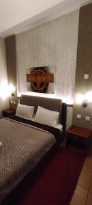 A bed or beds in a room at Erodios Guesthouse