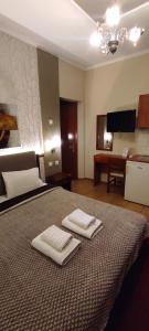 A bed or beds in a room at Erodios Guesthouse