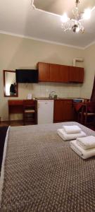 A bed or beds in a room at Erodios Guesthouse