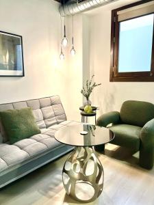 sala de estar con sofá y mesa en Apartamentos Real Suites Realejo en Granada