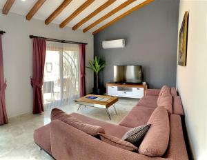 a living room with a couch and a table at Likya Akik 2+1 Villa, Özel Havuzlu in Fethiye