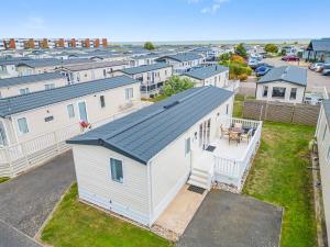 an aerial view of a white house with a yard at Escape to Paradise at Pevensey Bay Holiday Park 13 Woodland Walk in Pevensey