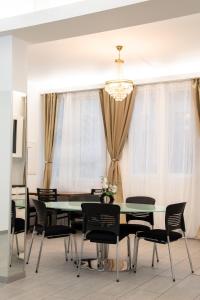 a dining room with a green table and black chairs at Guest Rooms Diamant Biel/Bienne in Biel