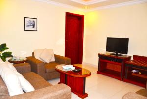Dorrat Al Jubail 3 في الجبيل: غرفة معيشة مع أريكة وتلفزيون