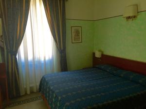 Posteľ alebo postele v izbe v ubytovaní Hotel Miramare