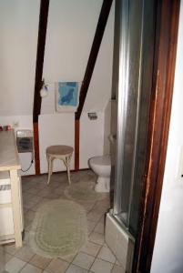 a bathroom with a toilet and a stool at Ferienhaus Bergwiese in Siegsdorf