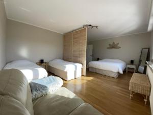 a living room with two beds and a couch at Domaine Rosfelder - locations de gîte et cabane insolite in Gertwiller