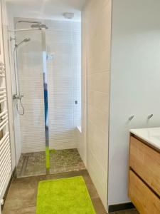 a bathroom with a shower with a green rug at Villa Les coquelicots La Baule in La Baule +48 photos