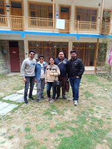a group of people standing in front of a building at Great Himalayan Nature View Resort in Banjār