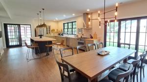 eine große Küche mit einem Holztisch und Stühlen in der Unterkunft Bold Stump Cottage in Lakeside