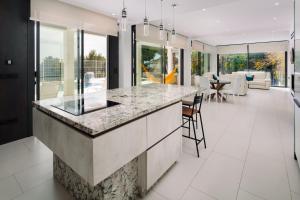 an open kitchen with a large island in a house at Villa Palacio Nazari in Málaga