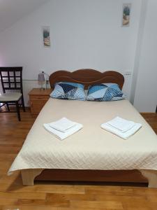ein Schlafzimmer mit einem Bett mit zwei Handtüchern darauf in der Unterkunft Hotel Daniel in Mukatschewo