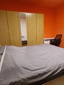 a bedroom with a bed and some wooden cabinets at Schick und Gemütlich in Ebenfurth