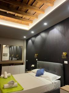 a bedroom with a large bed with a black wall at Sweet House Campo de’ Fiori in Rome