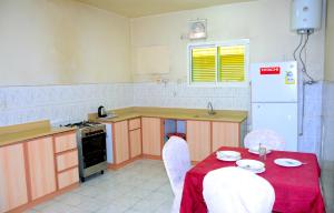 a kitchen with a table with a red table cloth at درة 1 in Al Jubail