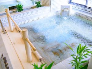 a jacuzzi tub in a house with water at Isshinkan in Nikko