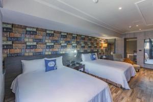 Postel nebo postele na pokoji v ubytování CU Hotel Kaohsiung