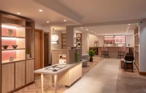 a lobby of a store with a table and a bar at Quality Hotel Hampstead in London