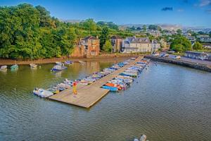 an aerial view of a dock with boats in the water at The Post House (Centre of riverside village) in Stoke Gabriel