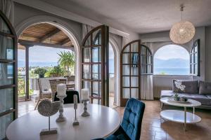 a living room with arched windows and a table at Selianitika Bay Γ2 Loft in Selianitika