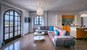 a living room with a couch and a table at Selianitika Bay Γ2 Loft in Selianitika +22 photos