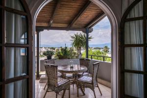 a patio with a table and chairs on a balcony at Selianitika Bay Γ2 Loft in Selianitika