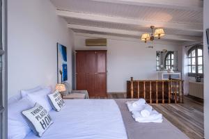 a bedroom with a large bed with towels on it at Selianitika Bay Γ2 Loft in Selianitika