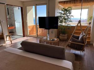 a living room with a couch and a flat screen tv at Suite 69 in Hurghada