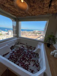 a bath tub filled with lots of red hearts at Suite 69 in Hurghada