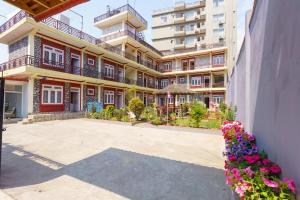 a large building with flowers in front of it at Hotel Angel in Pokhara