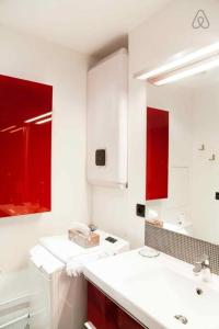 a bathroom with a white sink and red cabinets at Saint-Paul Vieux Lyon - parking included in Lyon