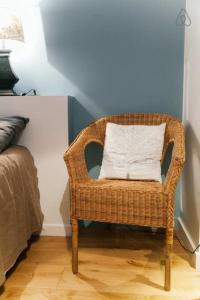 a wicker chair with a white pillow in a room at Saint-Paul Vieux Lyon - parking included in Lyon