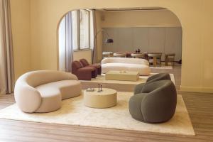 a living room with two beds and two chairs at Palacio Valderrabanos in Avila