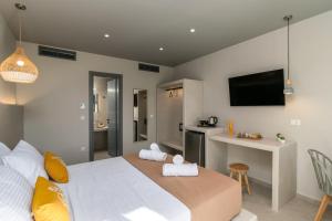 a bedroom with a large bed and a kitchen at Afroessa Milos in Adamas