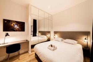 a hotel room with two beds and a desk at 70m2 of pure happiness in the centre - Rhône in Lyon