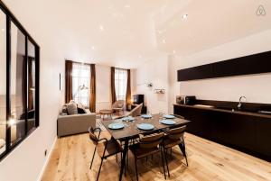 a large living room with a table and chairs at 70m2 of pure happiness in the centre - Rhône in Lyon
