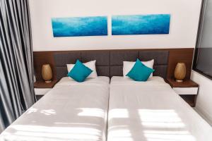 a bedroom with two beds with blue pillows at 2 BRs villa with private pool ( Villa 2 PN hồ bơi riêng) in Dien Khanh +22 photos