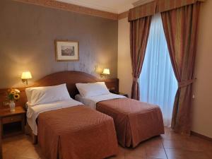 Postel nebo postele na pokoji v ubytování Hotel Squarciarelli