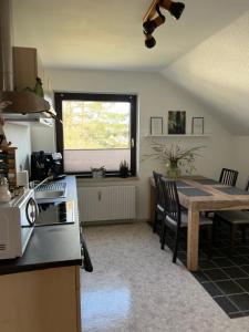 a kitchen and dining room with a table and chairs at Ferienwohnung Nannerl in Bad Sachsa