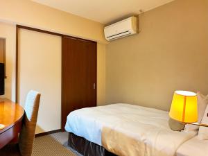 Postel nebo postele na pokoji v ubytování Nakajimaya Grand Hotel